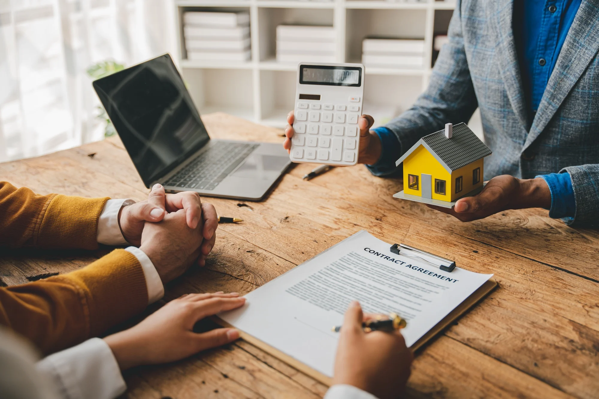 Real estate agents deliver replica homes to couples. Mortgage agreements, loans, leases and home sal